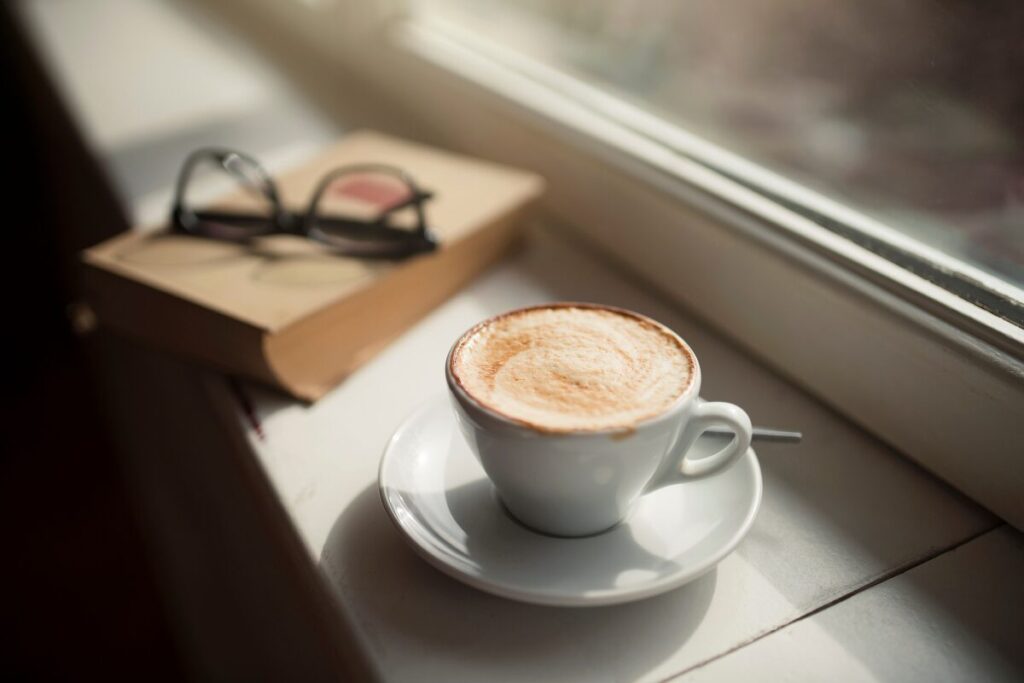窓辺のコーヒーカップと眼鏡